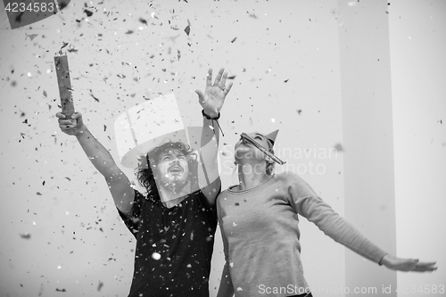 Image of romantic young  couple celebrating  party with confetti