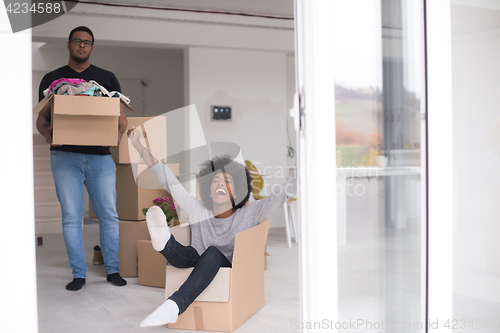 Image of African American couple  playing with packing material