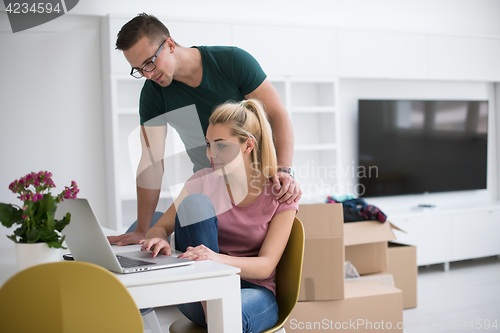 Image of Young couple moving in a new home