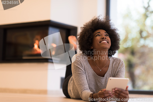 Image of black women using tablet computer on the floor