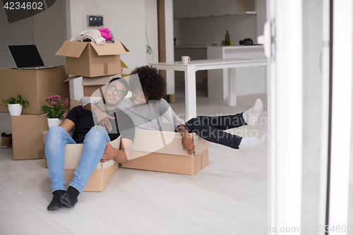 Image of African American couple  playing with packing material