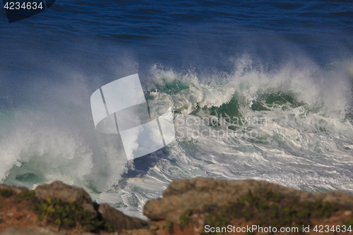 Image of Marine wave breaks against offshore stone