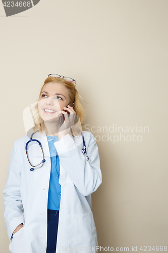 Image of Doctor in coat with phone