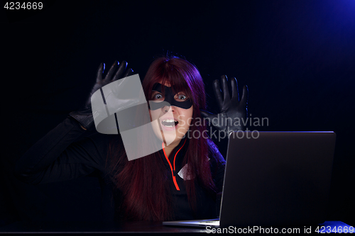 Image of Brunette hacker with raised hands