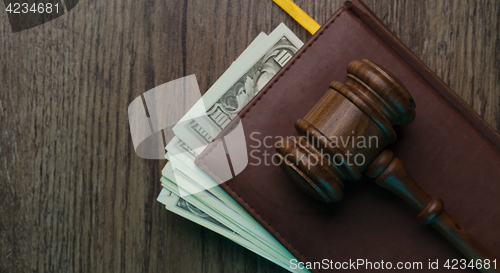 Image of Hammer on folder with money