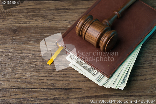 Image of Wooden table with hammer, money