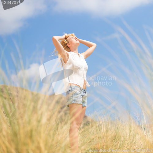 Image of Free Happy Woman Enjoying Sun on Vacations.