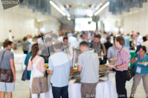 Image of Abstract blurred people socializing during lunch break at business conference.