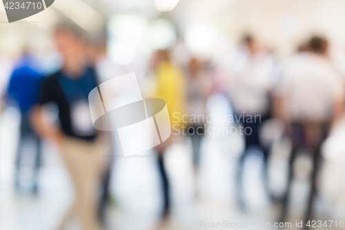 Image of Abstract blurred people socializing during coffee break at business conference.