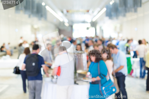 Image of Abstract blurred people socializing during lunch break at business conference.