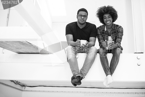 Image of couple having break during moving to new house