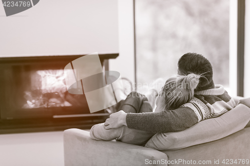 Image of Young couple  in front of fireplace