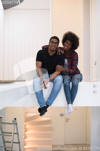 Image of couple having break during moving to new house