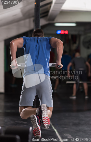 Image of man doing exercises parallel bars