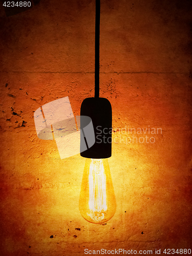 Image of Light bulb on vintage orange background