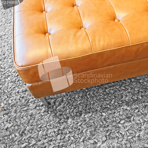 Image of Leather seat on gray wool carpet