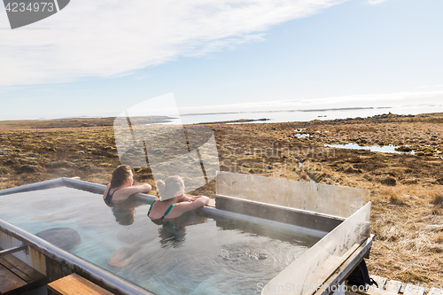 Image of Icelandic hotpot among the amazing lagoon and mountains