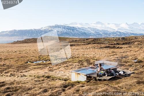 Image of Icelandic hotpot among the amazing lagoon and mountains