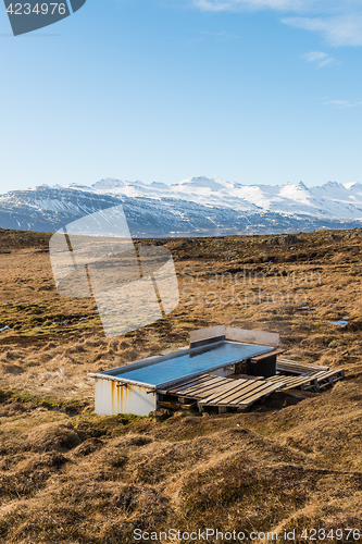 Image of Icelandic hotpot among the amazing lagoon and mountains