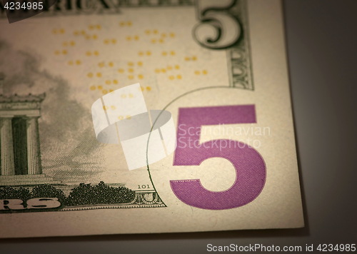 Image of   number 5 on the dollar bill