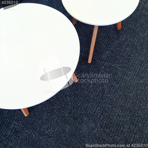 Image of Round white tables on carpet floor