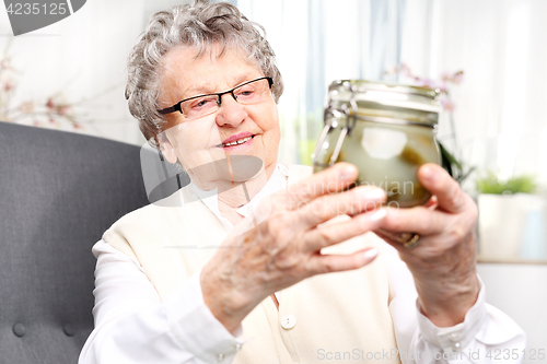 Image of Grandma&#39;s preserves, delicious place the jars for the winter Grandma&#39;s pantry, cucumbers in a jar