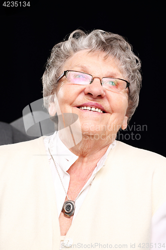 Image of Smiling grandmother Cheerful, smiling old woman sitting in the chair 