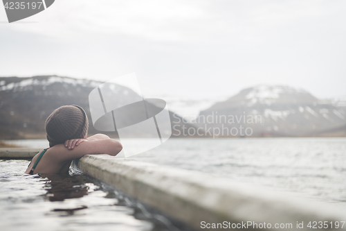 Image of Beautiful girl in a hot pot in Iceland during winter