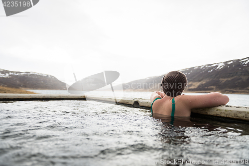 Image of Beautiful girl in a hot pot in Iceland during winter