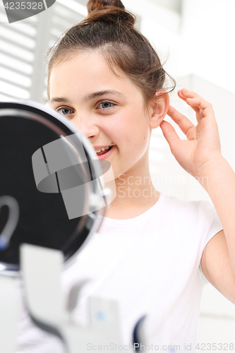 Image of Invisible hearing aid. The hearing aid for a child.