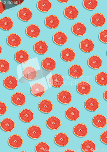 Image of Grapefruit pattern on blue background. Minimal flat lay concept.