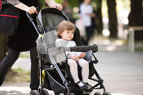 Image of baby girl sitting in the pram