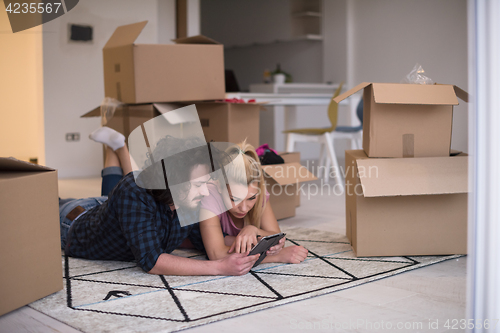 Image of Young couple moving in a new flat