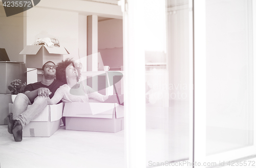 Image of African American couple  playing with packing material