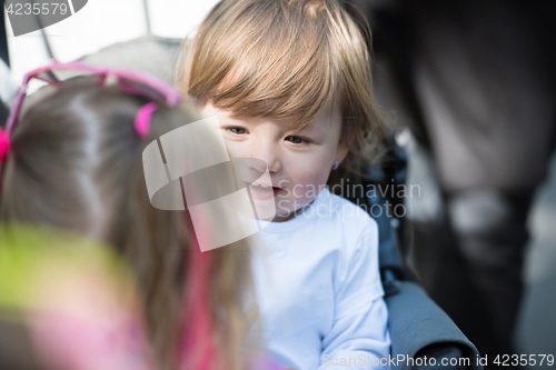 Image of baby girl sitting in the pram