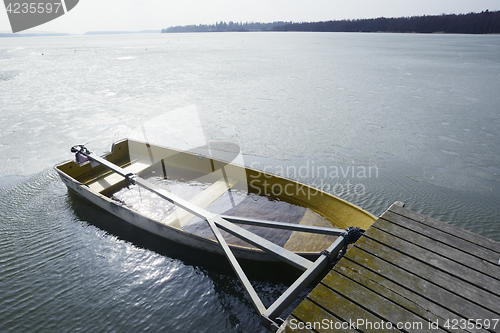 Image of a boat flooded with water at the pier