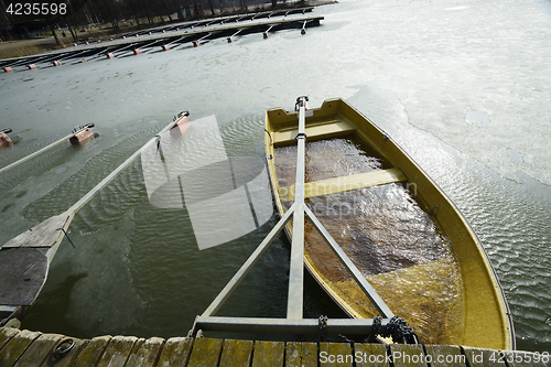 Image of a boat flooded with water at the pier