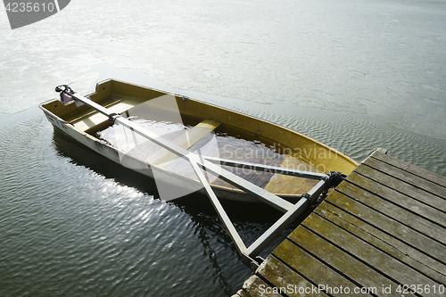 Image of a boat flooded with water at the pier