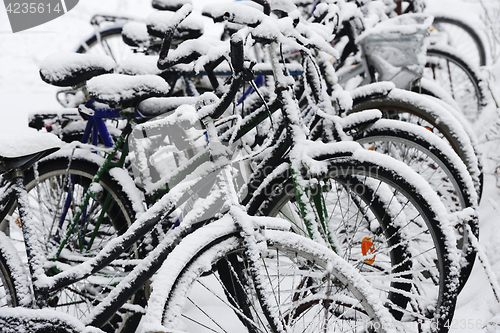 Image of bikes covered with a blanket of snow, winter in Finland