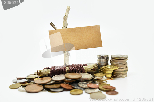 Image of Paper sign board with stack of coins