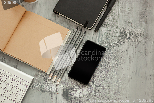 Image of Office desk table with computer, supplies and phone