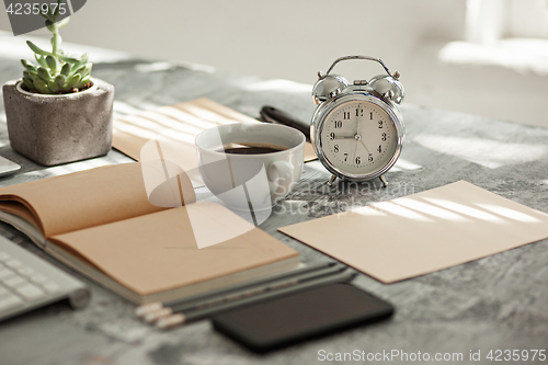 Image of Office desk table with computer, supplies and phone