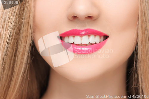 Image of The sensual red lips, mouth open, white teeth.