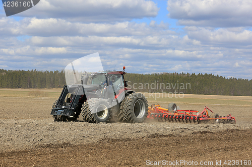 Image of Valtra Tractor and Cultivator on Field at Spring