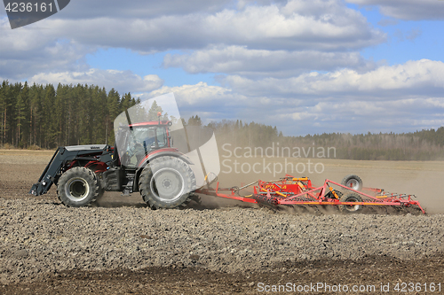 Image of Farm Tractor and Cultivator on Spring Field