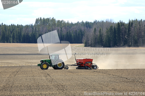 Image of John Deere Tractor and Seeder at Work on Field