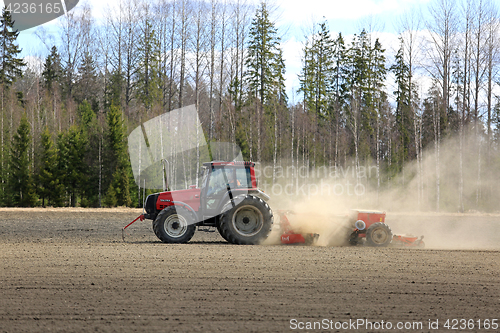 Image of Farmer Cultivates Field at Spring