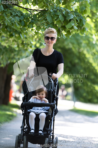 Image of mother pushed her baby daughter in a stroller