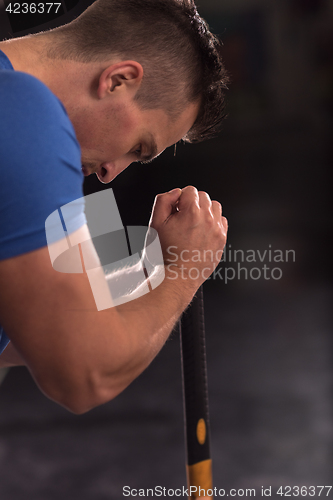 Image of man workout with hammer and tractor tire