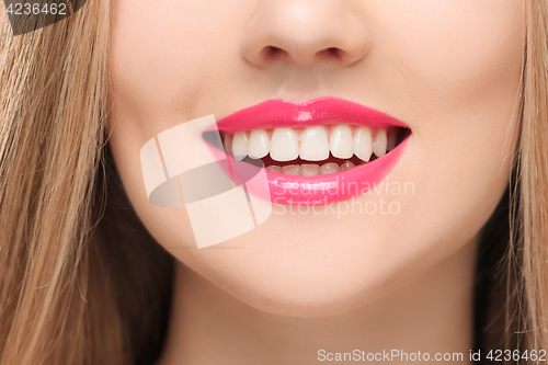 Image of The sensual red lips, mouth open, white teeth.